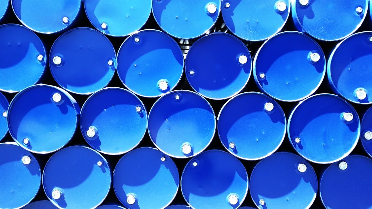 who-we-are-img Top view of stacked blue industrial drums forming a geometric pattern.